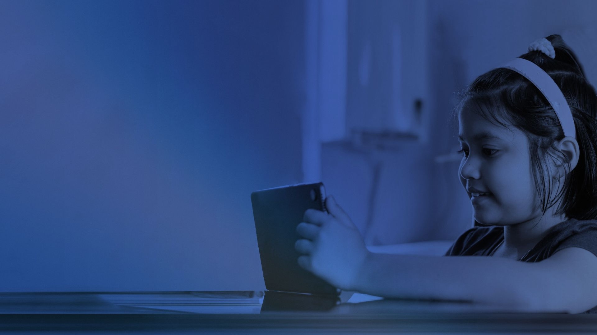 Girl taking an online class on a tablet at home